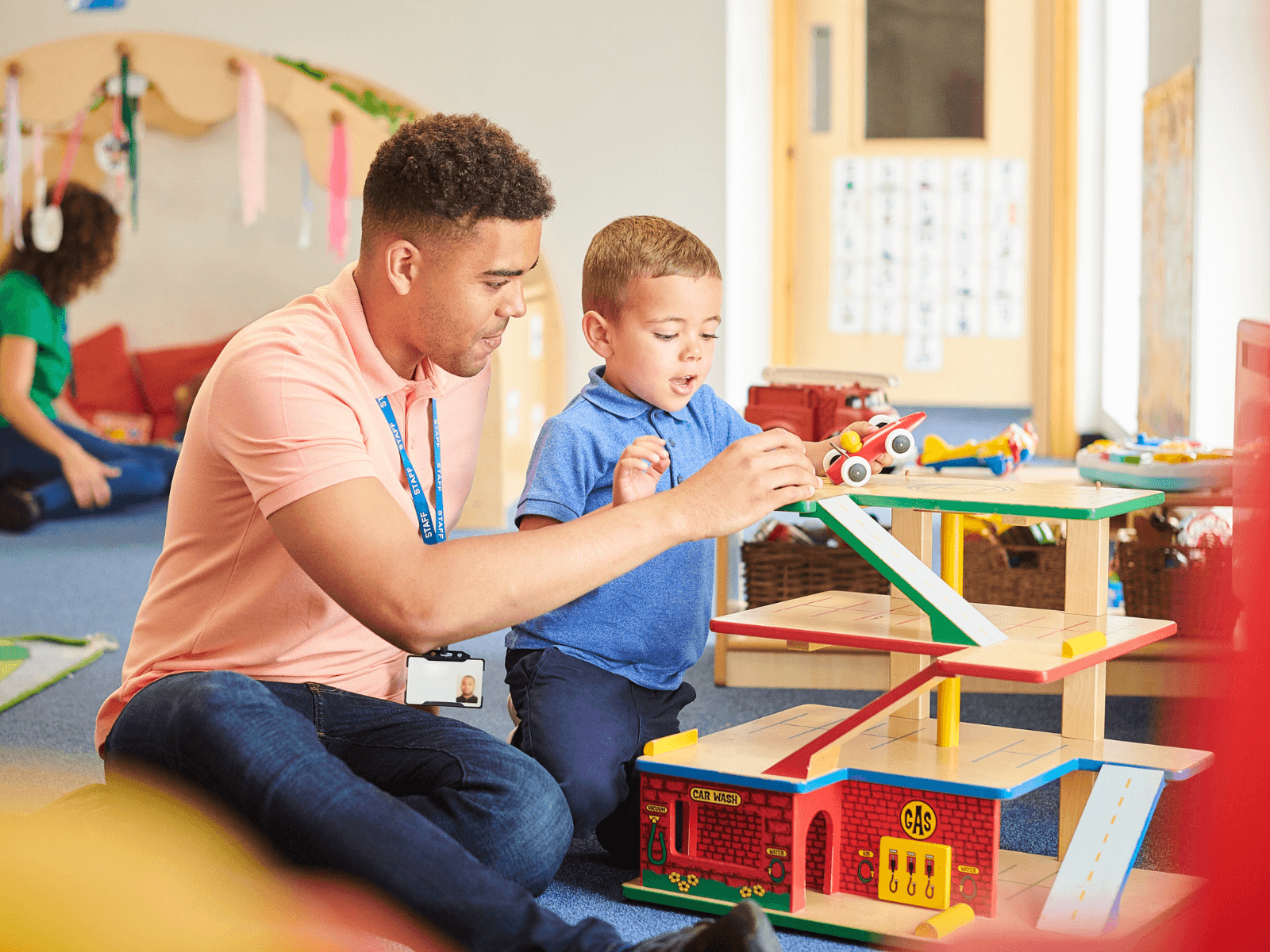 Nursery Staff Member and Child